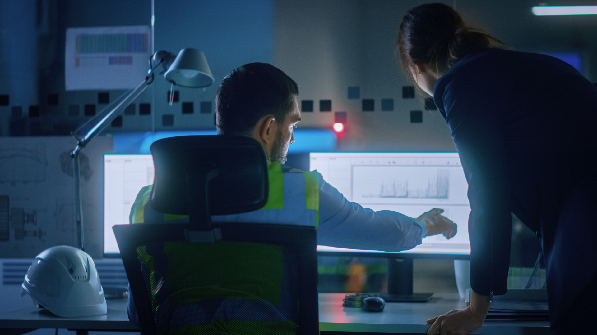 Two engineers looks at analysis from a simulation model on a computer screen