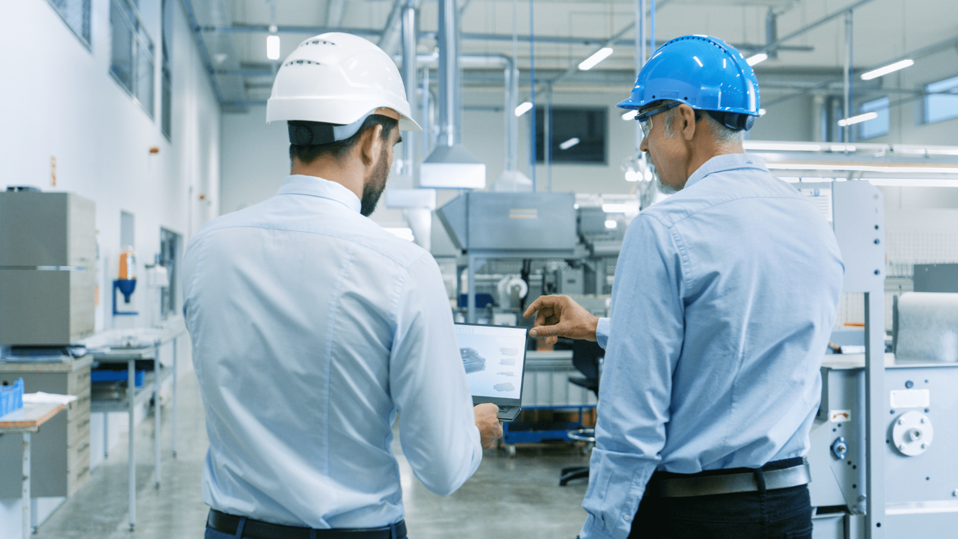 Engineers in a plant reviewing simulation modelling software