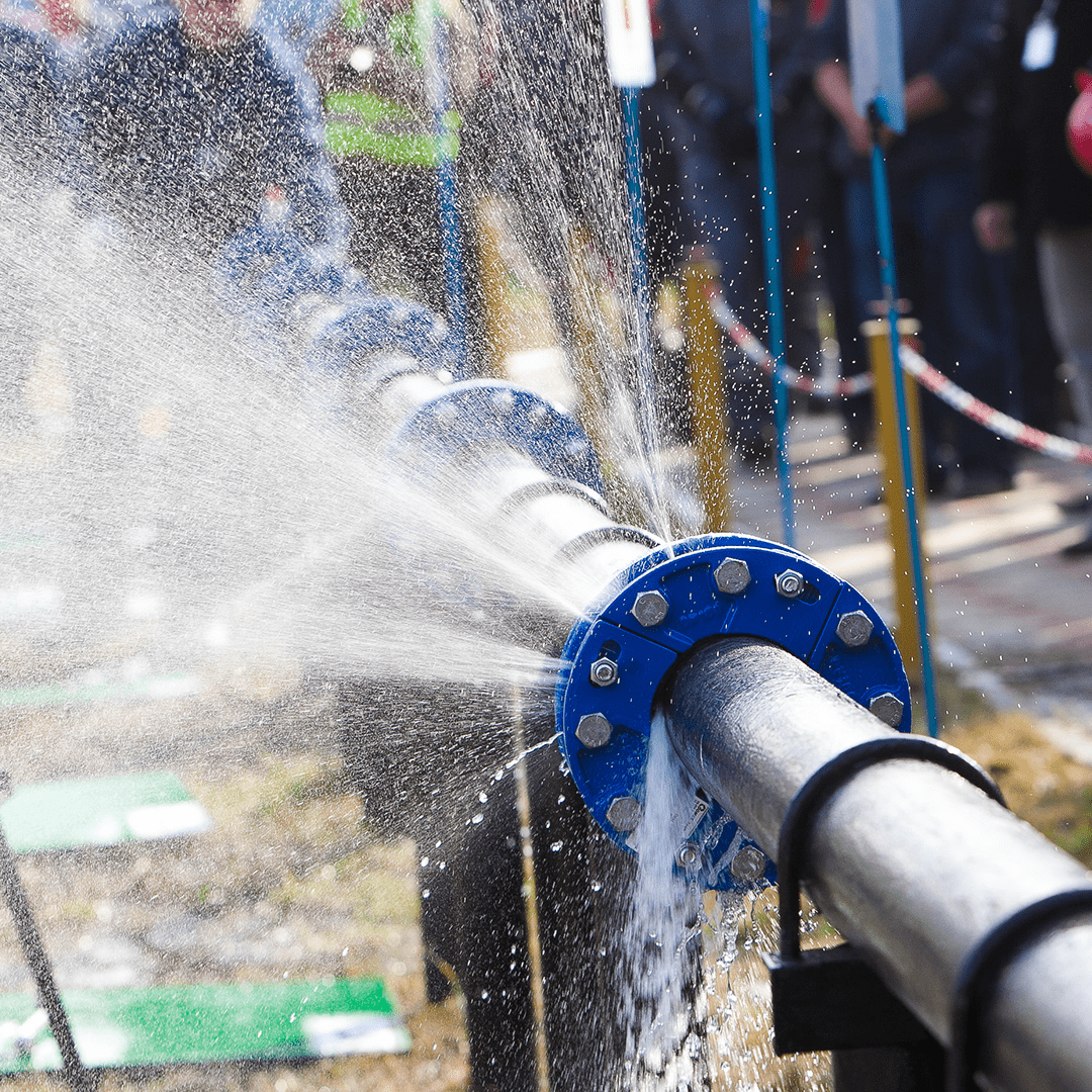 water spurts out from a burst pipe