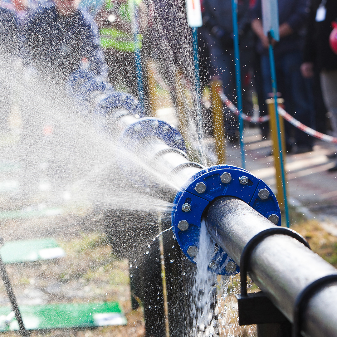 water spurts out from a burst pipe